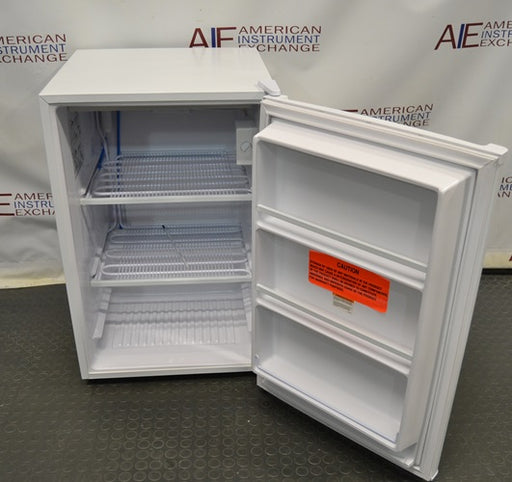 Open front view of a white Fisherbrand Isotemp undercounter laboratory unit showing internal wire shelves and door storage racks.