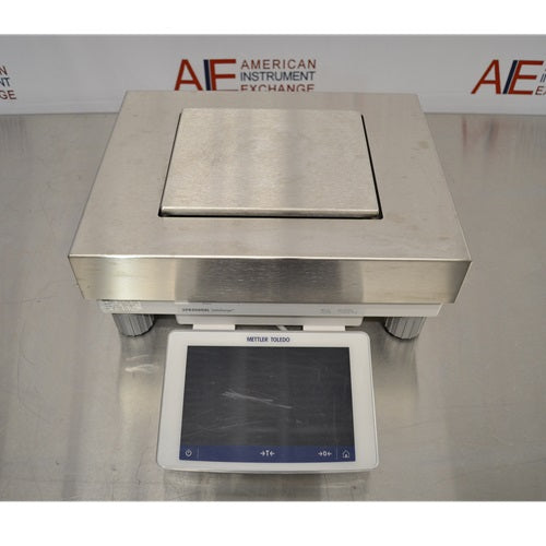 A front-facing overhead view of a Mettler Toledo XPR20002L Delta Range precision balance available from American Instrument Exchange, showing its square weighing pan and front-mounted digital touchscreen display.