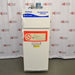 A front-facing view of a Fisher Scientific Isotemp explosion-proof laboratory refrigerator/freezer combination unit, showing its white double-door exterior, top-mounted compressor housing, and prominent red safety warning labels.