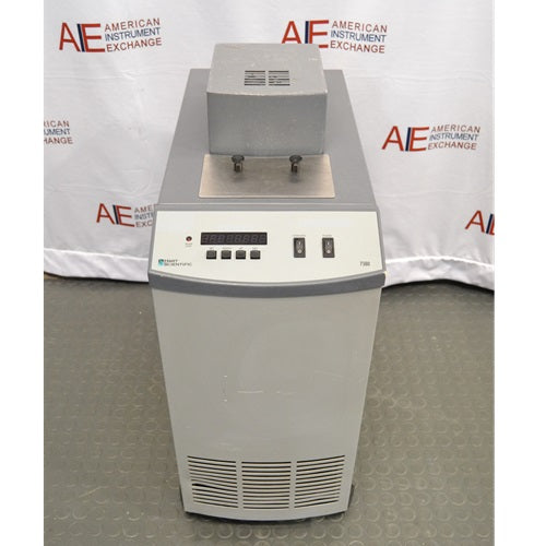A front-facing view of a Hart Scientific 7380 compact temperature calibration bath in front of an American Instrument Exchange backdrop, highlighting its digital control panel, top access port, and ventilation grille.