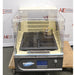 A front-facing view of the New Brunswick Innova 40R refrigerated incubator shaker, showing its clear acrylic lid, internal platform with a flask clamp, and the control panel labeled "Innova 40," positioned in front of an American Instrument Exchange backdrop.