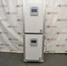 A front-facing view of two stacked PHCbi Cell-IQ series tri-gas cell culture incubators available from American Instrument Exchange, showing their control panels and white exterior.