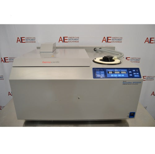 A front-facing view of a Thermo Savant SpeedVac SPD2030 vacuum concentrator system on a stainless steel lab table, showing its integrated control panel and top cover housing.