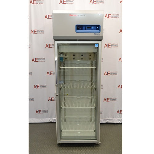 A front-facing view of a Thermo Scientific TSX1205GA laboratory refrigerator available from American Instrument Exchange, showing its glass door, internal wire shelving, and top-mounted digital control panel.