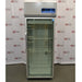A front-facing view of a Thermo Scientific TSX2305CA chromatography refrigerator available from American Instrument Exchange, showing its full-length glass door, wire interior shelving, and top-mounted digital control console.