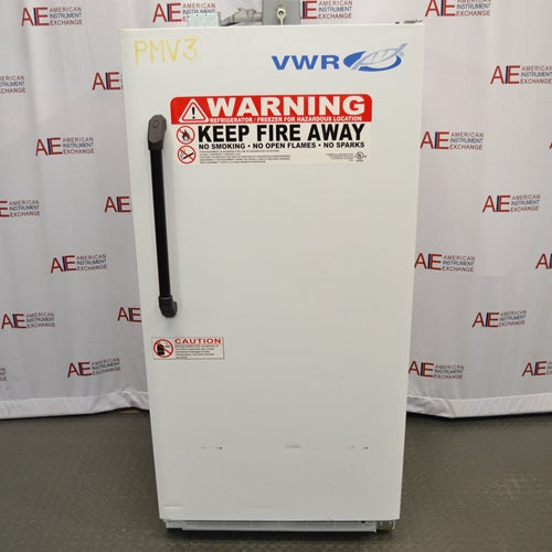 A front-facing view of a VWR explosion-proof refrigerator available from American Instrument Exchange, showing its solid white exterior door, prominent safety warning labels, and vertical handle.