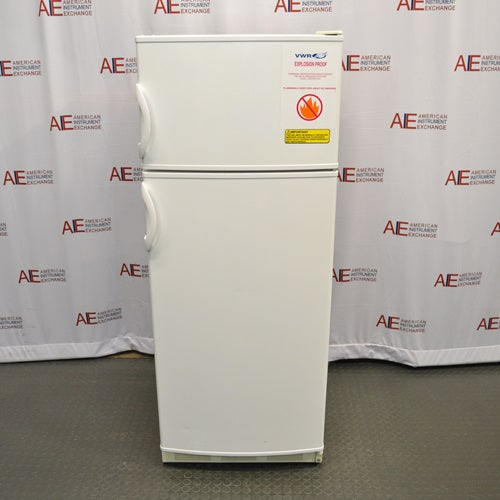 A front-facing view of a VWR explosion-proof refrigerator/freezer combination unit, showing its white double-door exterior, recessed side handles, and safety warning labels.