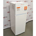 A front-left angled view of a white Thermo Scientific flammable material combination refrigerator/freezer on a lab floor, showing safety warning labels and serial specifications stickers on the upper freezer section against an American Instrument Exchange backdrop.