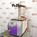 Angled front view of an SP Scientific BenchTop Pro freeze dryer featuring a purple front bezel, display screen, and top-mounted manifold with valves.
