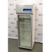 A front-facing view of a Thermo Scientific TSX1205GA laboratory refrigerator available from American Instrument Exchange, showing its glass door, internal wire shelving, and top-mounted digital control panel.