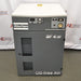 A front view of a grey and white Atlas Copco SF 4 FF oil-free scroll air compressor, featuring top-mounted control switches, a pressure gauge display, front ventilation slats, and "Oil-free Air" branding against an American Instrument Exchange backdrop.