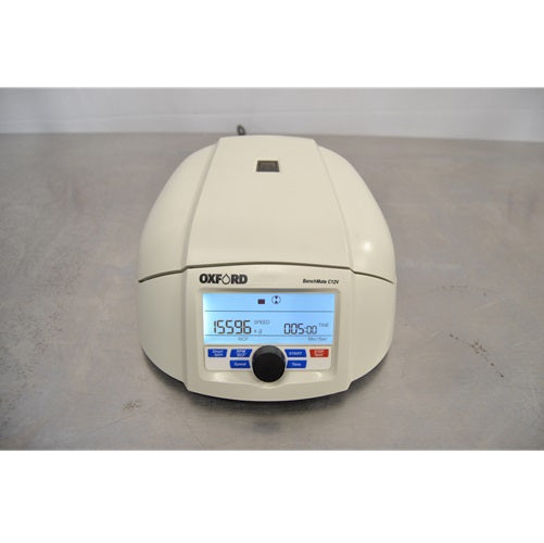A front view of an Oxford Lab Products Benchmate C12V microcentrifuge with its lid closed, showcasing the front control knob and illuminated digital screen displaying speed and run time settings.