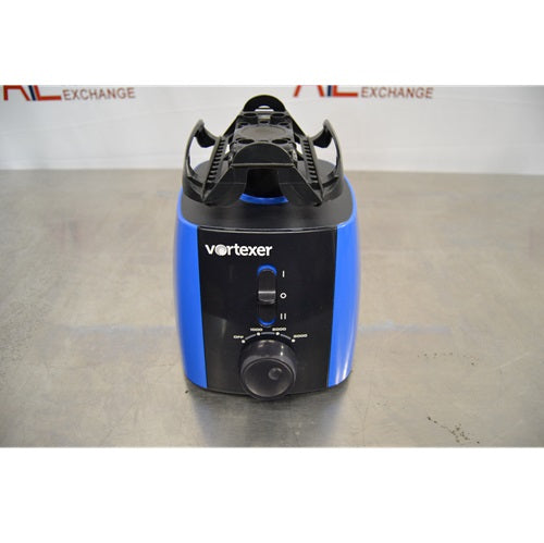 A front view of a blue and black Heathrow Scientific Vortexer featuring a top tube holder attachment, power toggle switch, speed adjustment knob, and front branding against an American Instrument Exchange backdrop.