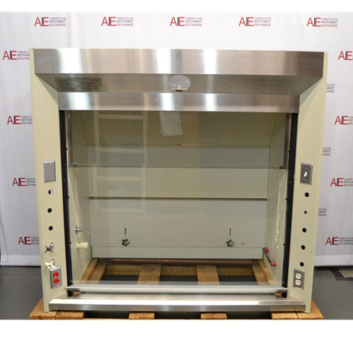 A front-facing view of a Jamestown chemical fume hood in front of an American Instrument Exchange backdrop, featuring a stainless steel header, clear glass sash, internal utility valves, and side electrical outlets.