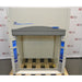 A front-facing view of a Labconco Protector Premier chemical fume hood mounted on a wooden pallet in front of an American Instrument Exchange backdrop, featuring a light grey exterior, Premier branding, dark grey fascia, clear sash, and side utility panels.