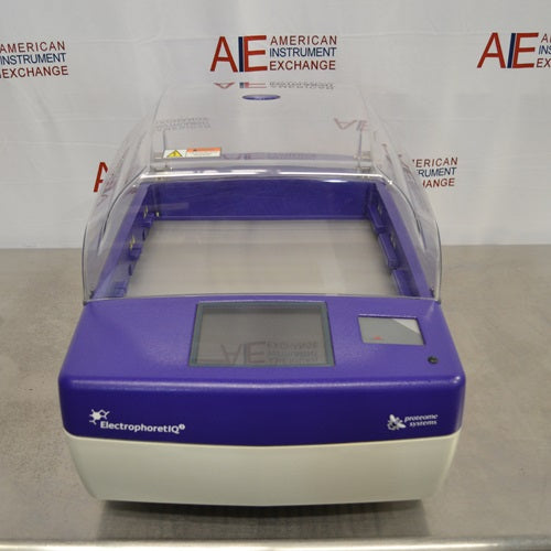 A front view of a blue and off-white Proteome Systems ElectrophoretIQ3 featuring a clear hinged lid, front display screen, and ElectrophoretIQ3 branding against an American Instrument Exchange backdrop.