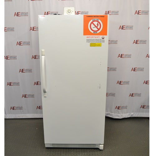 A full front view of a white Thermo Scientific 3552-10A flammable material storage freezer, featuring a large single door with a vertical handle on the left, top-mounted mechanical control dial, and prominent orange safety hazard label on the top right against an American Instrument Exchange backdrop.