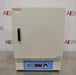 A head-on front view of a Thermo Scientific PR305225M Precision mechanical convection oven resting on a benchtop in front of an American Instrument Exchange backdrop, featuring a closed cream-colored front door with a black handle, a blue control panel at the base with a power switch, digital temperature display, and temperature adjustment knob.