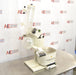 An elevated side view of a Buchi R-300 rotary evaporator system set on a stainless steel benchtop in front of an American Instrument Exchange backdrop, highlighting the glass condenser, receiving flask, motor drive unit, and heating bath.