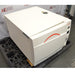 A high-angled perspective view of a Tuttnauer 3870ELP-B/L-D benchtop autoclave resting on a pallet in front of an American Instrument Exchange backdrop, displaying its front door, left side panel with serial label, top cover, and right side control panel.