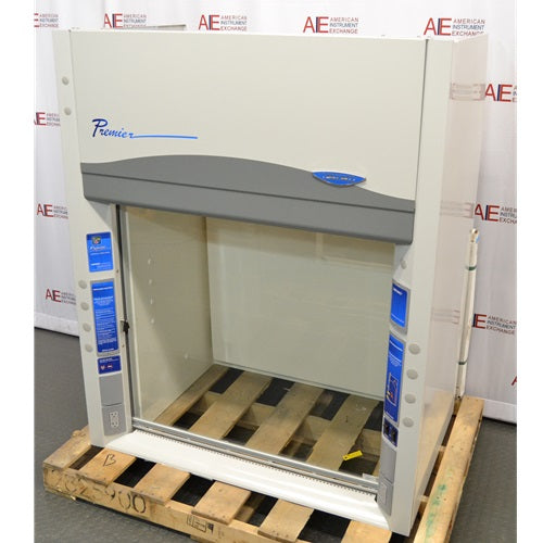 A high-angled view of a Labconco Protector Premier chemical fume hood on a wooden pallet in front of an American Instrument Exchange backdrop, displaying the upper panel, Premier logo, interior workspace, and front control side posts.