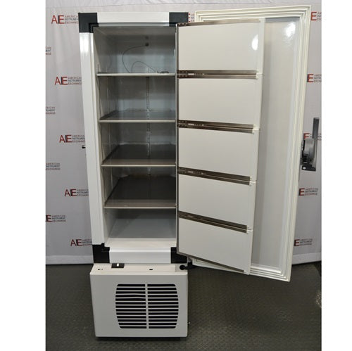 The interior of an open Fisherbrand Isotemp ultra-low temperature freezer, showing horizontal shelving and interior door compartments, standing in front of an American Instrument Exchange backdrop.