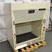A 4-foot wide Kewaunee Supreme Air chemical fume hood with a solid white color, featuring a black epoxy work surface, standard base cabinets, and control knobs on the sides.
