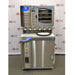 A front-facing view of the Labconco FreeZone 6-liter freeze dryer system equipped with a stoppering tray dryer, featuring stainless steel construction, multiple drying ports, and a control interface, set against an American Instrument Exchange backdrop.