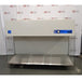 A front-facing view of a Labconco Purifier Horizontal Clean Bench model 3873021, featuring a white overhead housing unit, a large stainless steel work surface, and transparent side panels, set against an American Instrument Exchange backdrop.