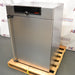 Angled front-right view of a closed Memmert HPP260 climate chamber resting on a wooden shipping pallet, displaying the front door, right side panel, vertical handle, and top digital control panel.