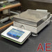 Side angled view of Mettler Toledo XSR4001S precision balance showing touchscreen terminal and stainless steel pan