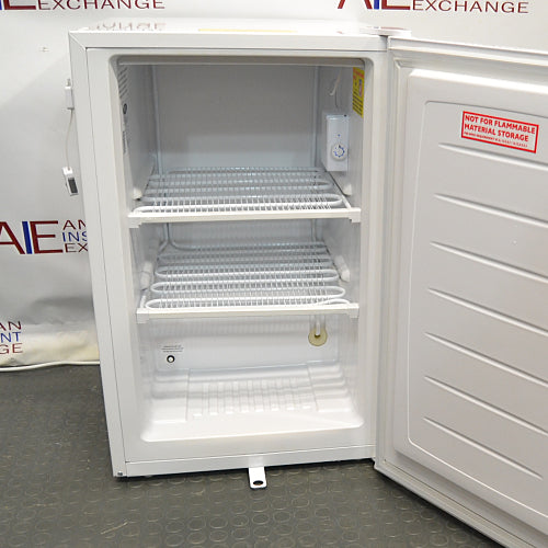 Compact white Norlake undercounter laboratory freezer with a solid front door and key lock.