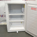 Compact white Norlake undercounter laboratory freezer with a solid front door and key lock.