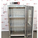 Open front view of a Shel Lab 2428 CO2 incubator showing stainless steel interior shelves and open door.