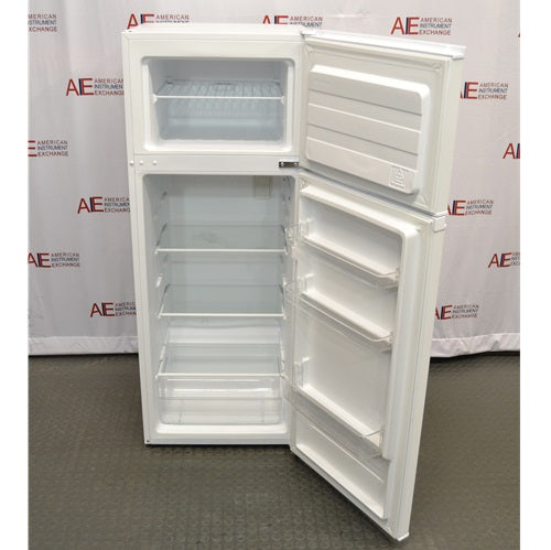 A front-angled view of an open white Thermo Scientific flammable material combination refrigerator/freezer, showing the interior upper freezer compartment with a shelf and the lower refrigerator compartment with glass shelves, clear storage drawers, and door racks against an American Instrument Exchange backdrop.