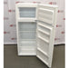 A front-angled view of an open white Thermo Scientific flammable material combination refrigerator/freezer, showing the interior upper freezer compartment with a shelf and the lower refrigerator compartment with glass shelves, clear storage drawers, and door racks against an American Instrument Exchange backdrop.