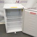 Open interior view of Norlake Scientific undercounter laboratory refrigerator with wire shelves and door warning label