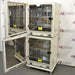 Open interior view of stacked Panasonic cellIQ CO2 laboratory incubators showing inner glass doors and stainless steel shelves