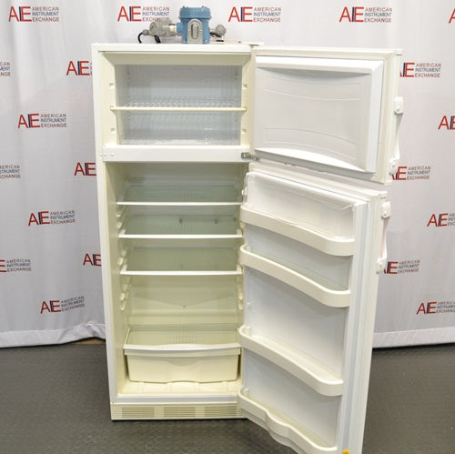 An open front-facing view of a Fisher Scientific Isotemp explosion-proof laboratory refrigerator/freezer combination unit, showing internal wire shelves, door bins, a bottom crisper drawer, and the top-mounted compressor housing.