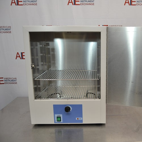 An open-door view of a Thermo Scientific PR305225G Precision laboratory oven sitting on a stainless steel surface, showing its interior stainless steel chamber, two wire racks, open front door, and blue control panel.