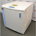 A right-angled view of a Thermo Scientific CryoPlus 4 cryogenic storage system, showing its closed lid with control panel and key lock, front panel with level gauge and blue vertical accent, and right side casing with attached hanging strap.