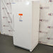 Right-angled view of an upright white VWR general purpose laboratory freezer with front warning label