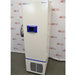 A right-side angled view of the white Fisherbrand Isotemp ultra-low temperature freezer, highlighting the blue control panel and front grille against an American Instrument Exchange backdrop.