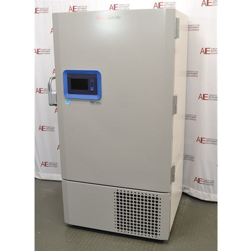 A right-side angled view of the grey Thermo Scientific RDE60086FA ultra-low temperature freezer, highlighting the blue digital control panel and front grille against an American Instrument Exchange backdrop.