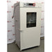 Angled front-right view of a closed, white Shel Lab 2428 CO2 incubator showing the glass window and right side panel.