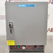 A gray Shel Lab SGO1E Economy Gravity Oven with a front door, control panel, and a caution sticker.