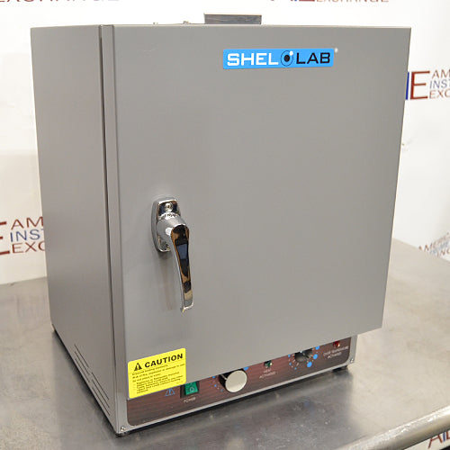 A gray Shel Lab SGO1E Economy Gravity Oven with a front door, control panel, and a caution sticker.