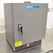 A gray Shel Lab SGO1E Economy Gravity Oven with a front door, control panel, and a caution sticker.