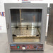 A gray Shel Lab SGO1E Economy Gravity Oven with a front door, control panel, and a caution sticker.
