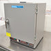 A gray Shel Lab SGO1E Economy Gravity Oven with a front door, control panel, and a caution sticker.